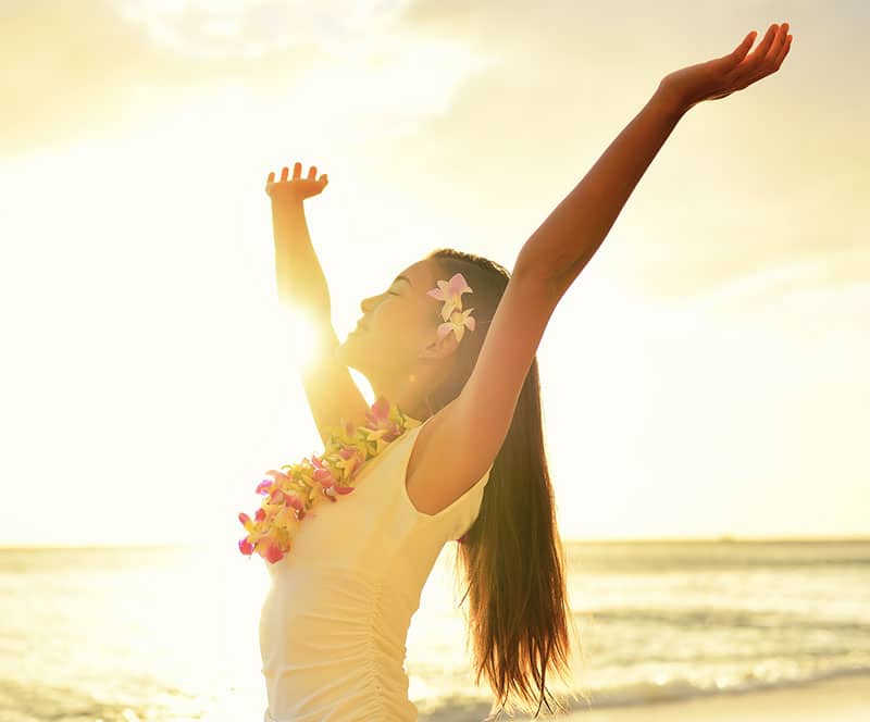 woman at beach smiling 