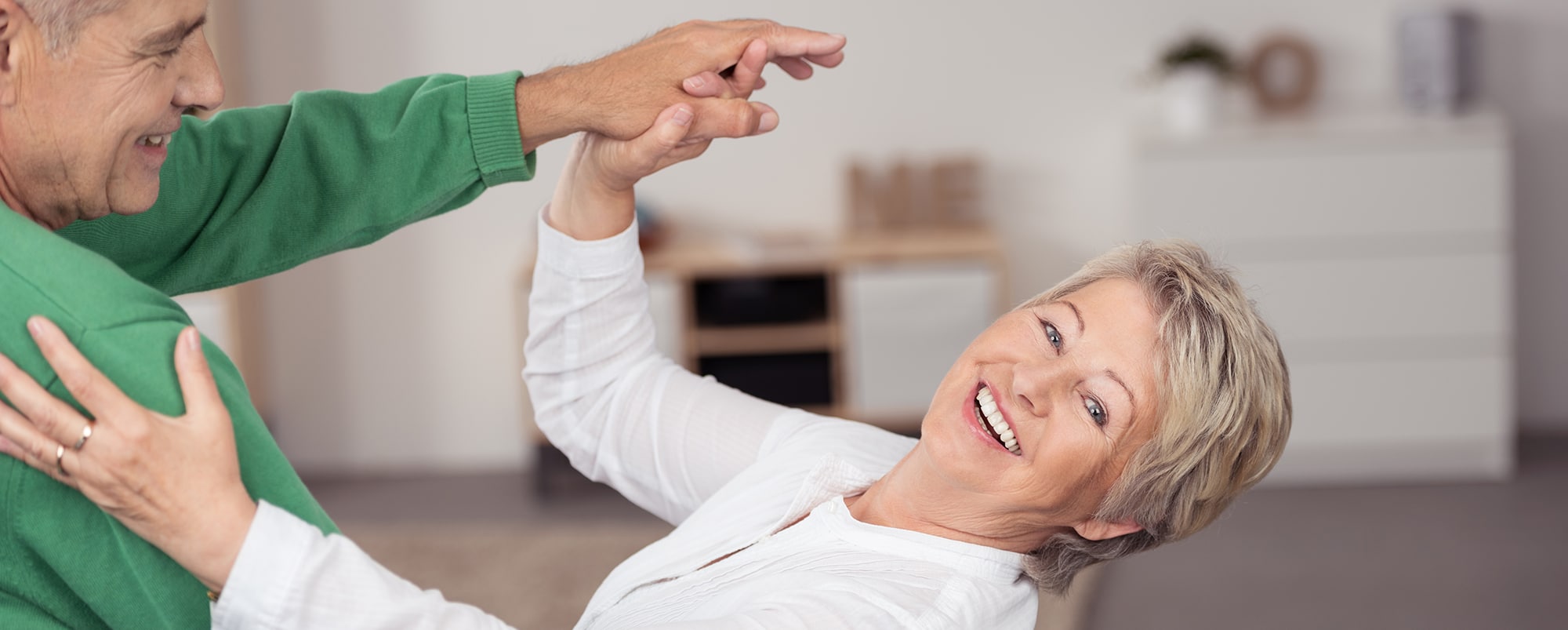 Mature couple smiling and dancing together